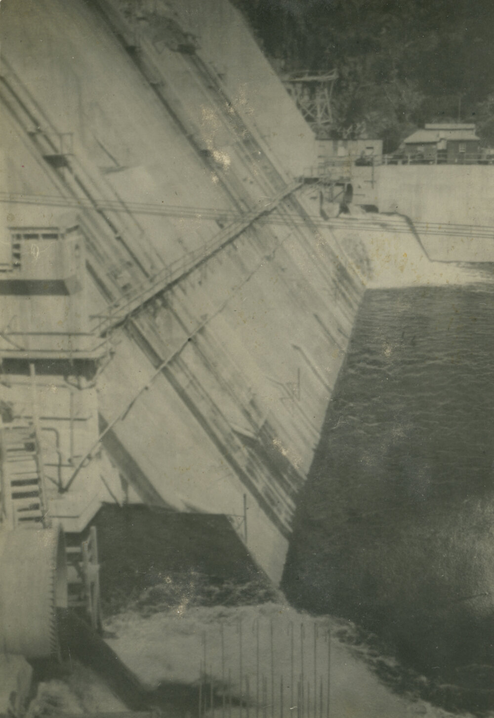 Somerset Dam wall as water gushes from pipes