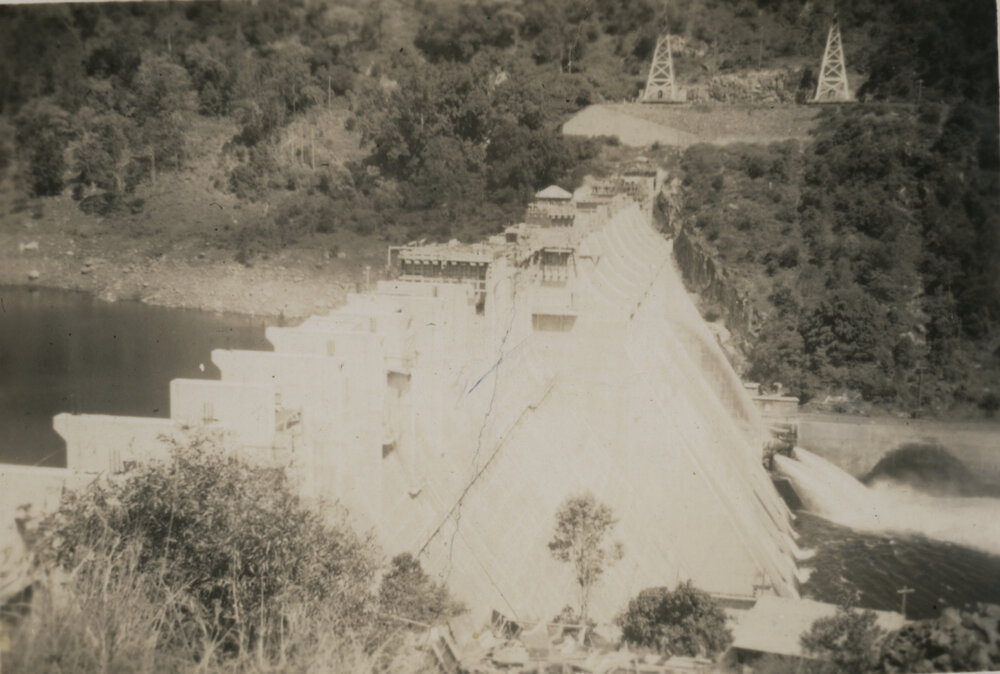 Somerset Dam wall as water gushes from pipes