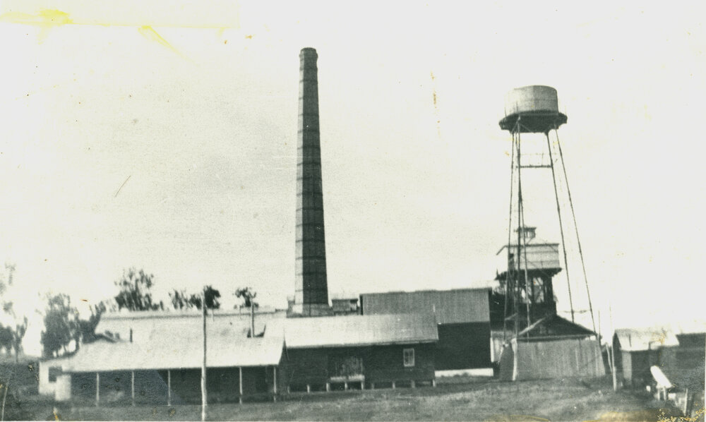 Toogoolawah condensed milk factory, showing water tower and brick chimney