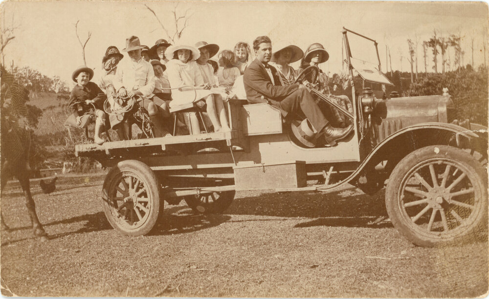 A group of people aboard a truck for a group outing