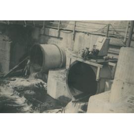 Somerset Dam wall showing protruding pipes and valves. Early construction photos, 1935-1943. 