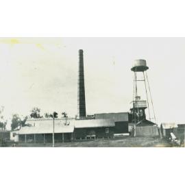 Toogoolawah condensed milk factory, showing water tower and brick chimney