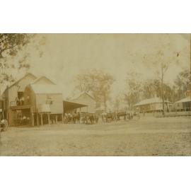 The McConnell condensery. Horses pulling milk carts, wait at the factory 